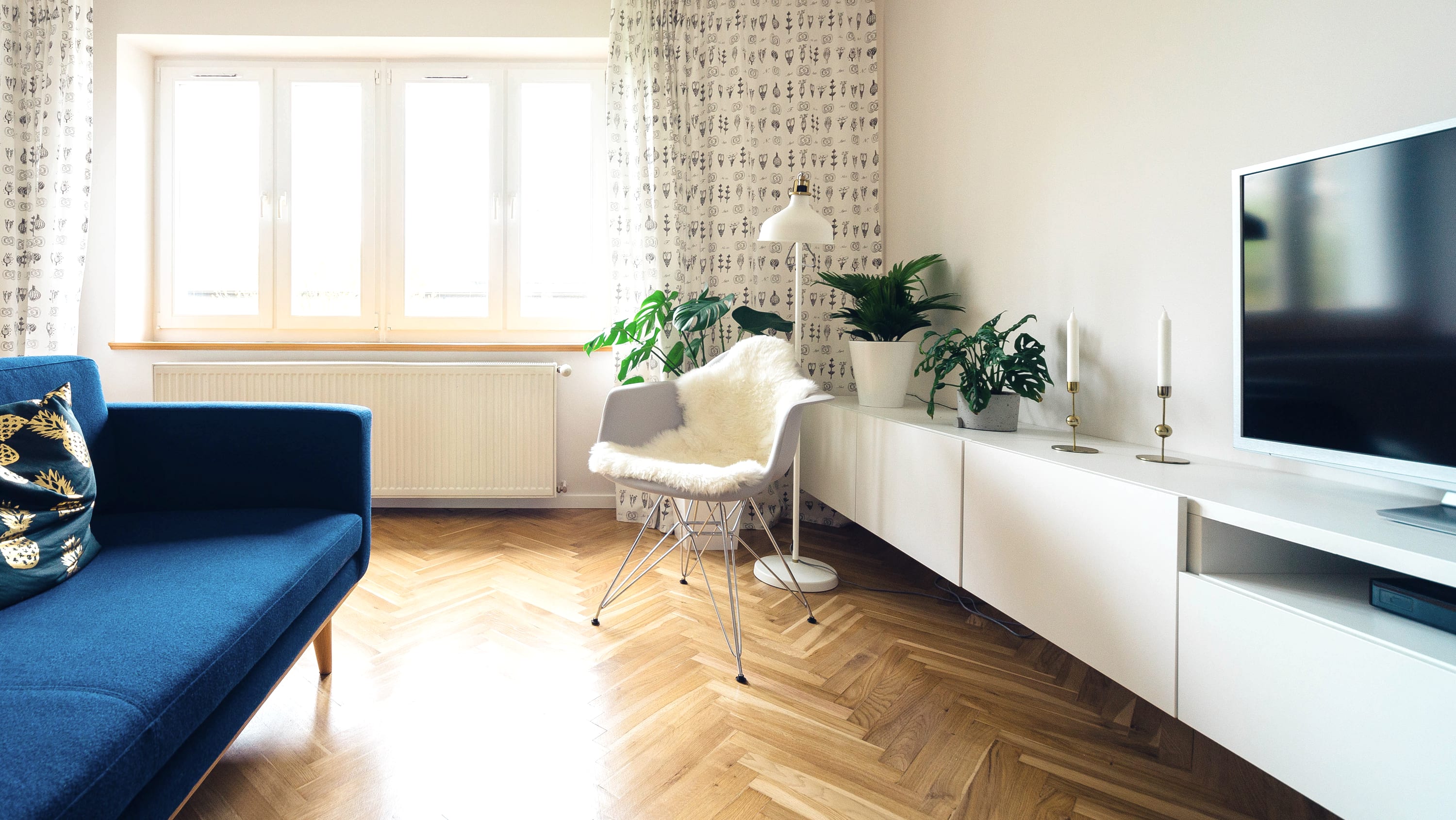 A bright living room with morning light across a timber floor