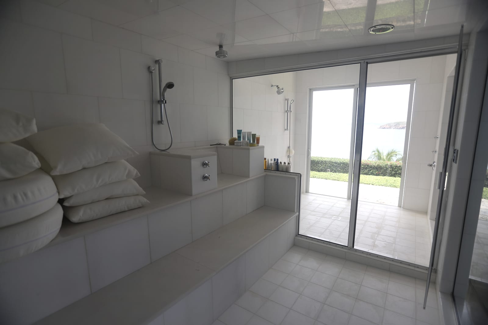 A white-tiled bathroom with daylight